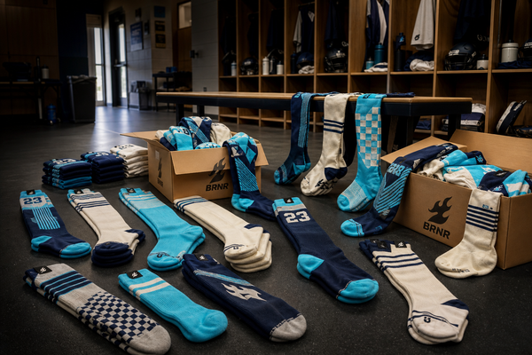 Custom team socks prepared for a full roster in a locker room